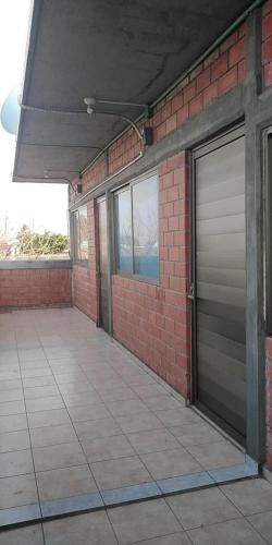 a building with a garage door and a brick wall at Departamento La iguana in Valente Díaz y La Loma