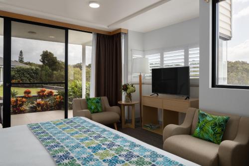 a hotel room with a bed and a flat screen tv at Sails Port Macquarie by Rydges in Port Macquarie