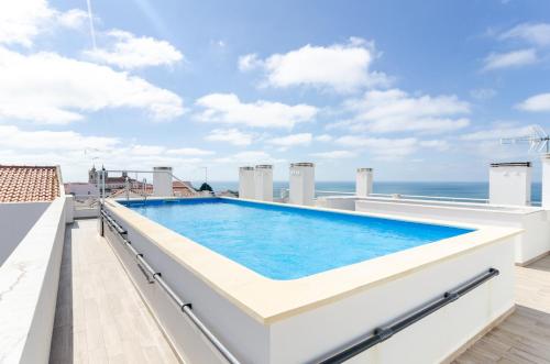 a swimming pool on the roof of a house at Pico Do Feliz - The Penthouse & The Village By Silver Prop in Nazaré