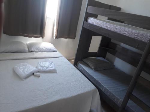 a bedroom with two bunk beds with towels on them at Apto Oniz Campos X in Campos dos Goytacazes