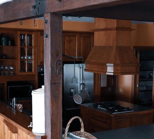 a kitchen with wooden cabinets and a stove top oven at The George at Yering in Yering