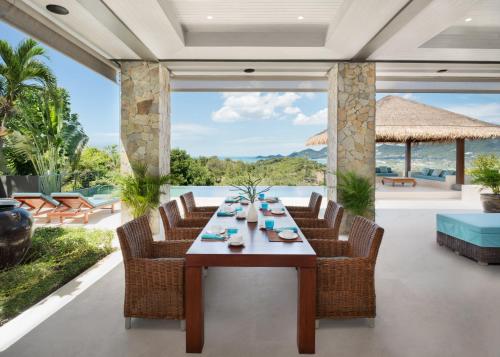 a dining room with a table and chairs at Baan Kimsacheva - Seaview Private Villa in Choeng Mon Beach