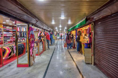 a store aisle of a store with people standing in it at Hotel Ibex in Manāli