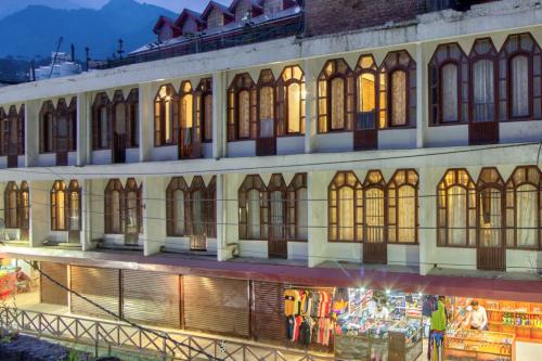 a large building with many windows at night at Hotel Ibex in Manāli