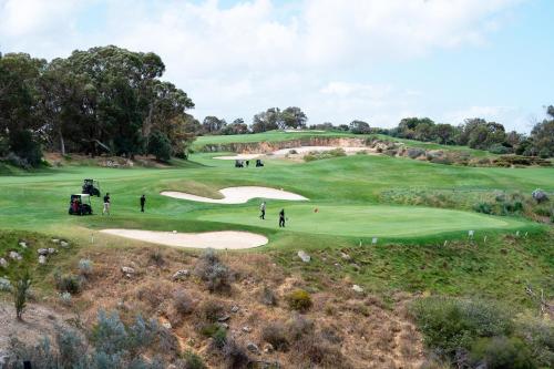 an aerial view of a golf course with people playing golf at Joondalup Resort in Perth