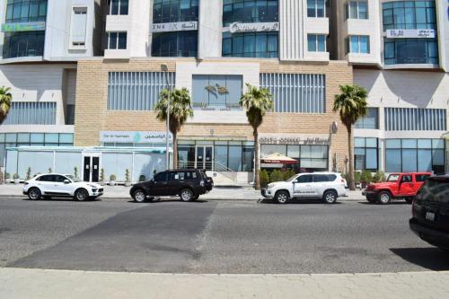 a group of cars parked in front of a building at Sedra Residence in Kuwait