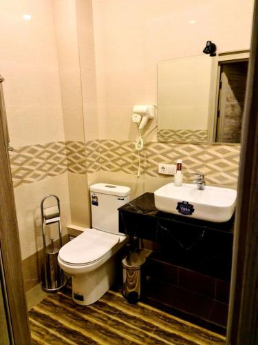 a bathroom with a toilet and a sink at Guest house TWINS in Tashkent