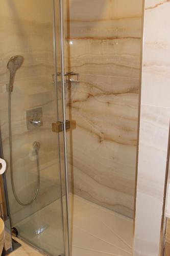 a shower with a glass door in a bathroom at Lale Hotel in Sapanca