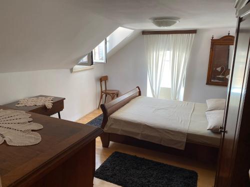 a bedroom with a bed and a desk and a window at Apartment Jimmy - luxury 65m2 two bedrooms aprtmnt in Dubrovnik