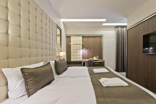 a large bed in a room with a wall at Congress Avenue Hotel in Vilnius