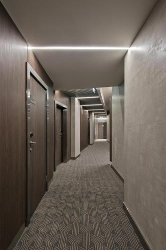 a corridor of an office building with a long hallway at Congress Avenue Hotel in Vilnius