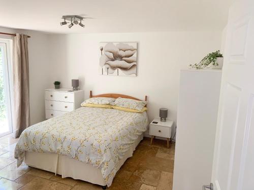 a bedroom with a bed and a painting on the wall at Mill Lodge in Brisley