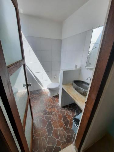 a bathroom with a sink and a toilet at Bumbung Bungalows in Amed