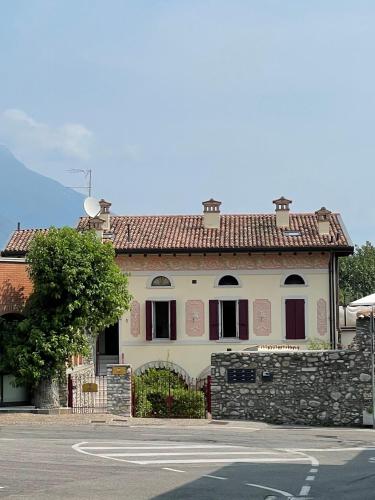 a large white building with a red roof at Barchi Resort - Apartments & Suites in San Felice del Benaco