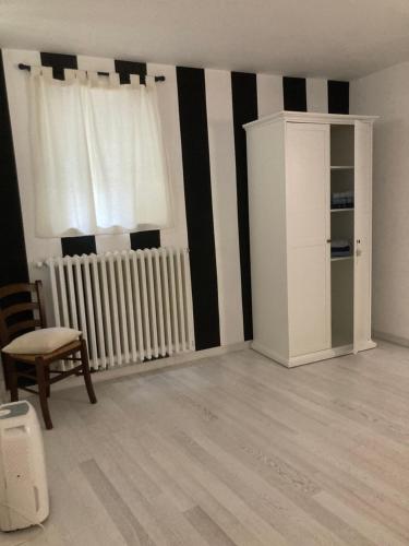 an empty living room with a radiator and a chair at La Casa Di Noah in Venosa
