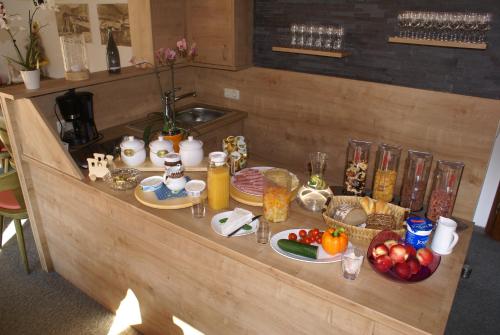a counter with a bunch of food on it at Pension Anneliese in Rauris