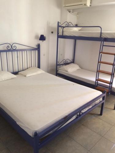 two bunk beds in a room with a ladder at EL GRECO in Rhodes Town