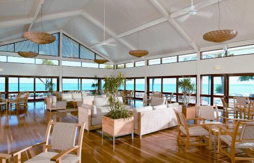 a large room with chairs and tables and windows at Heron Island in Heron Island