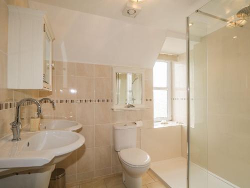 a bathroom with a toilet and a sink and a shower at Harbour View in Buckie