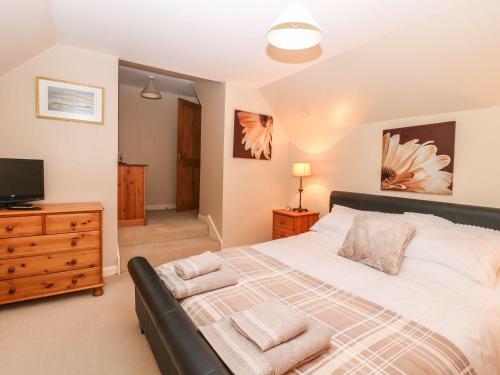 a bedroom with a large bed and a tv at Harbour View in Buckie