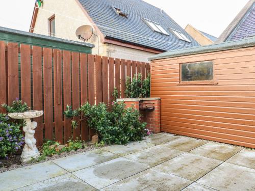 a wooden fence in front of a house at Harbour View in Buckie
