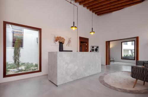 a living room with a concrete counter and a table at Alinea Suites Limassol Center in Limassol