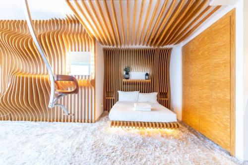a bedroom with a bed and a chair at Futuristic & Unique Studio along Dubai Water Canal in Dubai