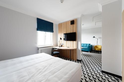 a hotel room with a bed and a desk at Hotel Tulip Residences Warsaw Targowa in Warsaw