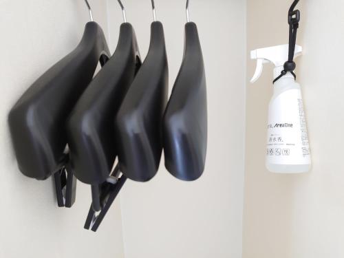 a bunch of black umbrellas hanging on a wall at Hotel Area One Oita in Oita