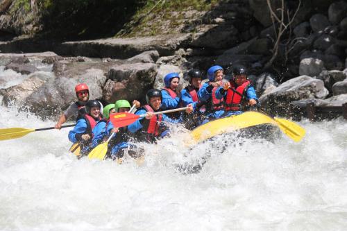 a group of people are rafting on a river at Tauernlodge Sonnblick Top 2 in Mühlbach am Hochkönig