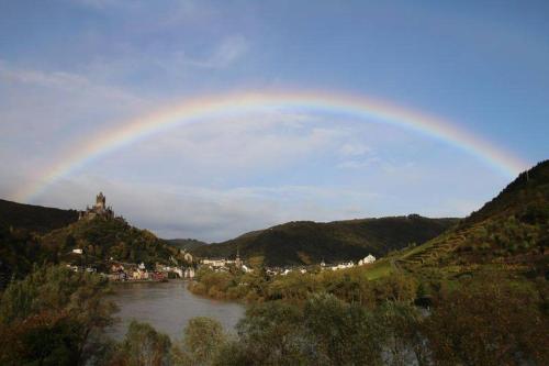 a rainbow in the sky over a river at Haus Burgfrieden Cochem in Cochem