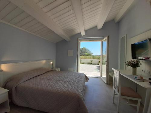 a bedroom with a bed and a desk and a television at B&B Camera e Caffè in Osimo
