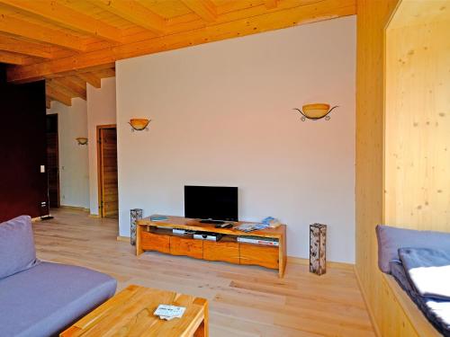 een woonkamer met een bank en een tv bij Ferienwohnung Schöpf in Kiefersfelden