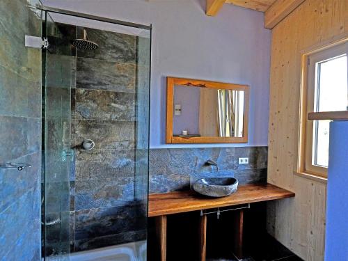 a bathroom with a sink and a glass shower at Ferienwohnung Schöpf in Kiefersfelden