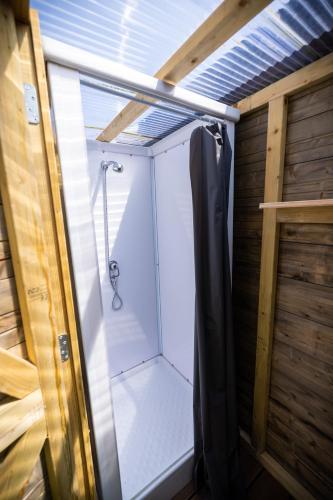 a shower with a glass door in a bathroom at Jachthaven Nieuwboer in Bunschoten