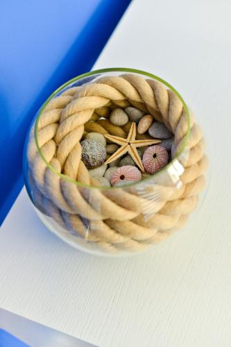 a wicker basket with rocks and a starfish at Nautical rooms Old town in Zadar