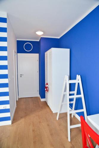a room with a ladder and a blue wall at Nautical rooms Old town in Zadar