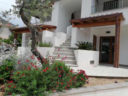 a house with flowers in front of it at Kind of Blue in Cala Gonone