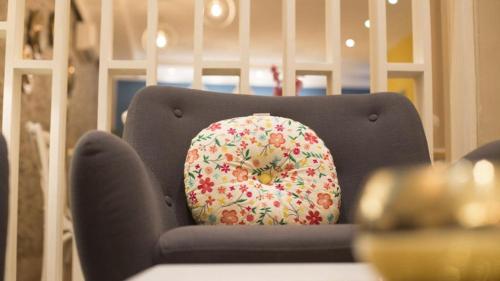 a donut pillow sitting on top of a chair at The Best Centric Hotel in Nouakchott