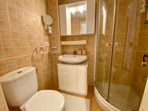 a bathroom with a toilet and a sink and a shower at Beautiful apartment in the centre of Nerja in Nerja