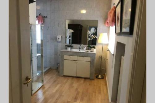 a bathroom with a sink and a mirror at Vrijstaande rietgedekte villa nabij uitvalswegen in Wassenaar