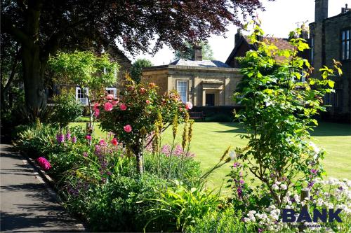 a garden with flowers in front of a house at Beautiful old bank in Bakewell in Bakewell