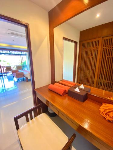 a room with a wooden table with a mirror at Le Murraya Boutique Serviced Residence & Resort in Chaweng