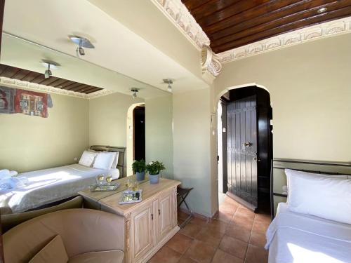 a bedroom with two beds and a sink and a mirror at Archontika Karamarlis in Makrinítsa
