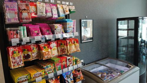 a store with a display of food and snacks at Hotel Area One Oita in Oita