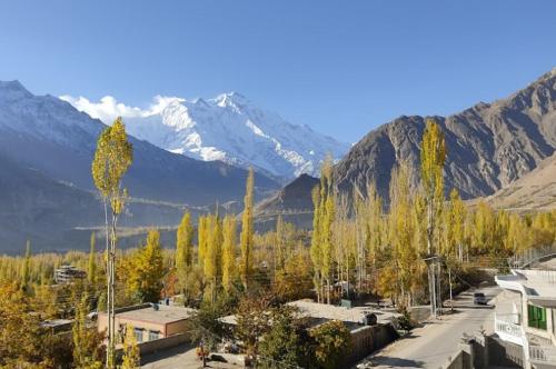 a view of a town with mountains in the background at Hunza Hidden Palace in Alīābād