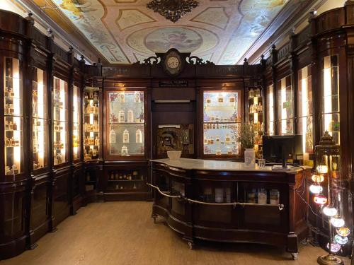 a bar in a room with a clock on the ceiling at Pharmacia GuestHouse in Coimbra