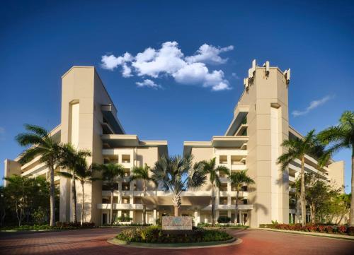 a large white building with palm trees in front of it at Hyatt Vacation Club at Hacienda del Mar in Dorado