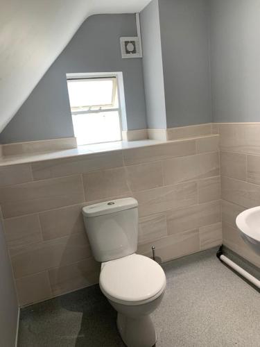 a bathroom with a white toilet and a sink at The Ivy in Lincolnshire