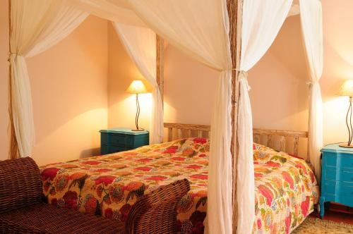 a bedroom with a bed with a canopy at Casa Do Foral in Rio Maior